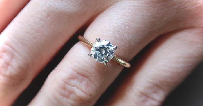 Lady wearing diamond and gold engagement ring