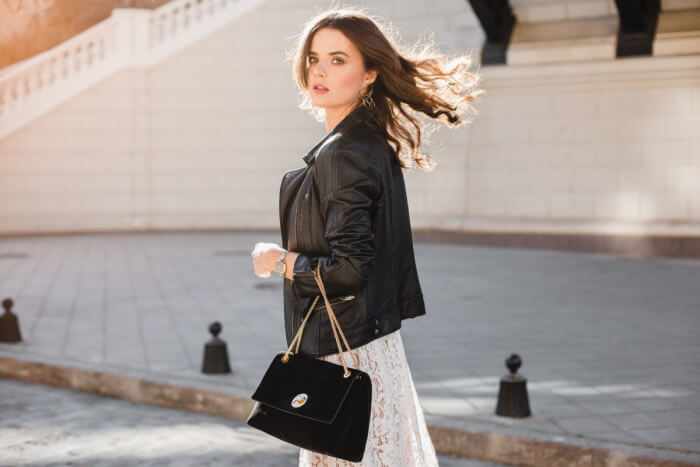 Woman with designer handbag walking in street